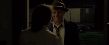 Movie still from “The Old Man & the Gun” (2018), directed by David Lowery – An older man wearing a suit and a hat talking to an older woman; Medium shot, Over the shoulder angle