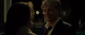 Movie still from “The Old Man & the Gun” (2018), directed by David Lowery – A man in a suit and tie talking to a woman in a suit; Close Up shot, Over the shoulder angle