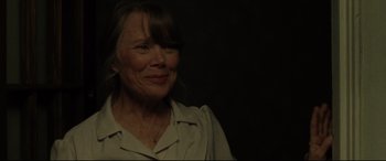 Movie still from “The Old Man & the Gun” (2018), directed by David Lowery – An older woman smiling with her eyes closed; Close Up shot, Over the shoulder angle