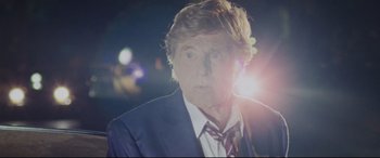 Movie still from “The Old Man & the Gun” (2018), directed by David Lowery – An older man wearing a suit and tie; Close Up shot, Low angle