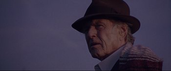 Movie still from “The Old Man & the Gun” (2018), directed by David Lowery – An older man wearing a hat and a suit; Close Up shot, Low angle