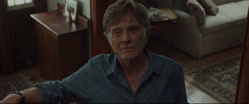 Movie still from “The Old Man & the Gun” (2018), directed by David Lowery – An older man wearing a blue button up shirt; Close Up shot, Over the shoulder angle