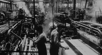 Movie still from “The Organizer” (1963), directed by Mario Monicelli – A group of men working in an industrial setting; Extreme Wide shot, High angle