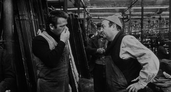 Movie still from “The Organizer” (1963), directed by Mario Monicelli – A group of men standing next to each other in a room; Medium shot, Over the shoulder angle