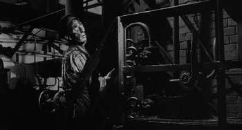 Movie still from “The Organizer” (1963), directed by Mario Monicelli – An old man in a black and white photo; Medium shot, Low angle