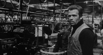 Movie still from “The Organizer” (1963), directed by Mario Monicelli – Two men working in an industrial setting; Medium shot, Low angle