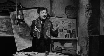 Movie still from “The Organizer” (1963), directed by Mario Monicelli – A black and white photo of a man talking to a group of people; Medium shot, Over the shoulder angle