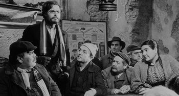 Movie still from “The Organizer” (1963), directed by Mario Monicelli – A black and white photo of a group of men; Medium shot, Over the shoulder angle