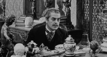 Movie still from “The Organizer” (1963), directed by Mario Monicelli – A man sitting at a table with a tea pot; Close Up shot, High angle