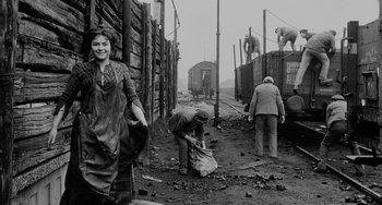 Movie still from “The Organizer” (1963), directed by Mario Monicelli – An old black and white photo of people working on a train track; Wide shot, Over the shoulder angle