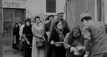 Movie still from “The Organizer” (1963), directed by Mario Monicelli – A group of people standing in a line with pots; Wide shot, High angle