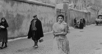 Movie still from “The Organizer” (1963), directed by Mario Monicelli – An old photo of a man and a woman on the street; Wide shot, High angle