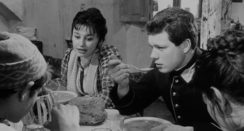 Movie still from “The Organizer” (1963), directed by Mario Monicelli – A man and a woman sitting at a dinner table; Medium shot, High angle