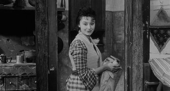 Movie still from “The Organizer” (1963), directed by Mario Monicelli – A young woman holding something in her hands; Medium shot, High angle