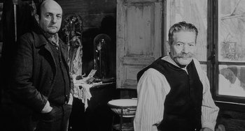 Movie still from “The Organizer” (1963), directed by Mario Monicelli – A man standing next to another man in front of a mirror; Medium shot, Over the shoulder angle