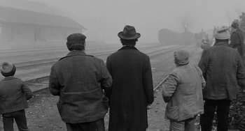 Movie still from “The Organizer” (1963), directed by Mario Monicelli – A group of people standing on a train track; Wide shot, Low angle