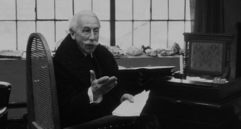 Movie still from “The Organizer” (1963), directed by Mario Monicelli – An older man sitting at a table with papers; Close Up shot, Over the shoulder angle