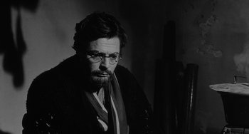 Movie still from “The Organizer” (1963), directed by Mario Monicelli – A black and white photo of a man with glasses; Close Up shot, Over the shoulder angle