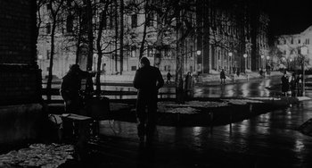Movie still from “The Organizer” (1963), directed by Mario Monicelli – A man walking down the street in the rain at night; Wide shot, Low angle
