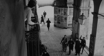 Movie still from “The Organizer” (1963), directed by Mario Monicelli – A black and white photo of people walking down a street; Wide shot, High angle