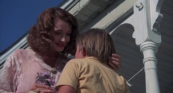 Movie still from “The Other” (1972), directed by Robert Mulligan – A woman and a boy standing next to each other; Medium shot, Over the shoulder angle