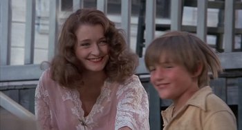 Movie still from “The Other” (1972), directed by Robert Mulligan – A woman and a young boy smiling for the camera; Close Up shot, Low angle