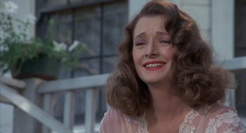 Movie still from “The Other” (1972), directed by Robert Mulligan – A person with curly hair smiling; Close Up shot, Over the shoulder angle