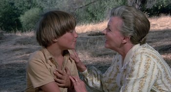 Movie still from “The Other” (1972), directed by Robert Mulligan – An older woman and a young boy in a field; Close Up shot, Over the shoulder angle