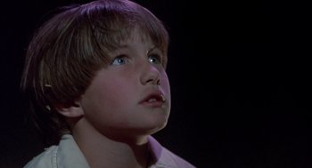 Movie still from “The Other” (1972), directed by Robert Mulligan – A young boy looking up into the air; Close Up shot, Low angle
