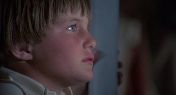 Movie still from “The Other” (1972), directed by Robert Mulligan – A young boy's face looking up; Close Up shot, Low angle