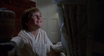 Movie still from “The Other” (1972), directed by Robert Mulligan – A young boy sitting in front of a television; Close Up shot, Low angle