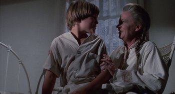 Movie still from “The Other” (1972), directed by Robert Mulligan – An older woman and a young boy in a room; Medium shot, Low angle