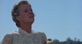 Movie still from “The Other” (1972), directed by Robert Mulligan – An older woman wearing a white dress looking up at the sky; Close Up shot, Low angle