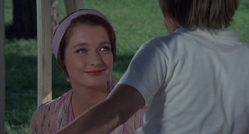 Movie still from “The Other” (1972), directed by Robert Mulligan – A young woman is smiling while a young man is touching her hair; Close Up shot, Over the shoulder angle