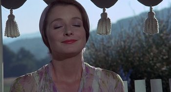 Movie still from “The Other” (1972), directed by Robert Mulligan – A woman with a head scarf is looking up at the sky; Close Up shot, Low angle