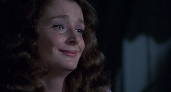 Movie still from “The Other” (1972), directed by Robert Mulligan – A person with long brown hair; Close Up shot, Over the shoulder angle