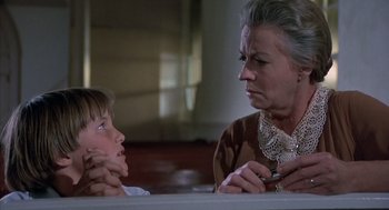 Movie still from “The Other” (1972), directed by Robert Mulligan – An older woman talking to a young boy in front of a mirror; Close Up shot, Low angle