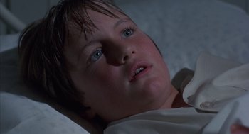 Movie still from “The Other” (1972), directed by Robert Mulligan – A young boy laying in a bed looking up at the sky; Close Up shot, Low angle