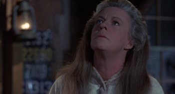 Movie still from “The Other” (1972), directed by Robert Mulligan – A person with long blonde hair looking up; Close Up shot, Low angle