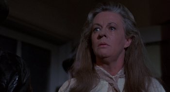 Movie still from “The Other” (1972), directed by Robert Mulligan – An older woman with long gray hair crying; Close Up shot, Low angle