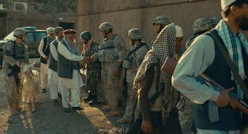Movie still from “The Outpost” (2019), directed by Rod Lurie – A group of men in fatigues standing next to each other; Wide shot, Over the shoulder angle