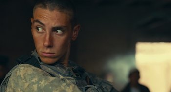 Movie still from “The Outpost” (2019), directed by Rod Lurie – A man in fatigues looking into the distance; Close Up shot, Low angle