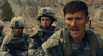 Movie still from “The Outpost” (2019), directed by Rod Lurie – Two men in military fatigues are standing on a hill; Close Up shot, Over the shoulder angle