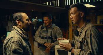 Movie still from “The Outpost” (2019), directed by Rod Lurie – A group of men standing next to each other holding cups; Medium shot, Over the shoulder angle