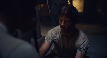 Movie still from “The Outpost” (2019), directed by Rod Lurie – A man sitting in front of another man in a dark room; Close Up shot, Over the shoulder angle
