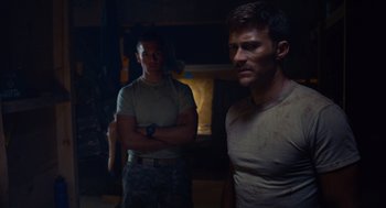 Movie still from “The Outpost” (2019), directed by Rod Lurie – Two men standing next to each other in the dark; Medium shot, Over the shoulder angle