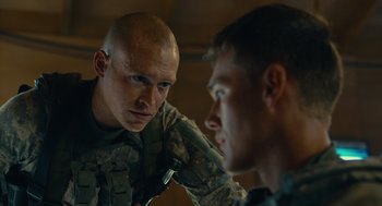 Movie still from “The Outpost” (2019), directed by Rod Lurie – Two men in military uniforms looking at each other; Close Up shot, Over the shoulder angle