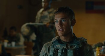 Movie still from “The Outpost” (2019), directed by Rod Lurie – A man in a military uniform looking at the camera; Close Up shot, Over the shoulder angle