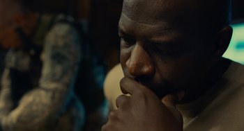 Movie still from “The Outpost” (2019), directed by Rod Lurie – A person with his hand to his face; Close Up shot, Over the shoulder angle