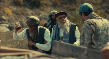 Movie still from “The Outpost” (2019), directed by Rod Lurie – A group of men standing next to each other on top of a hill; Medium shot, Over the shoulder angle